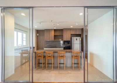 Modern kitchen with wooden cabinets and island seating