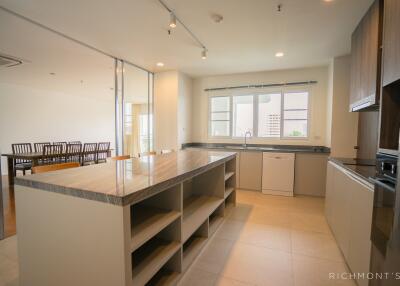 Modern kitchen with an island, ample storage, and a view of the dining area