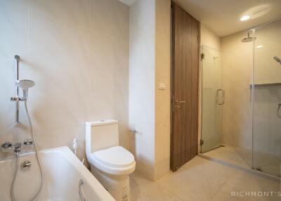 Modern bathroom with bathtub, toilet, and shower