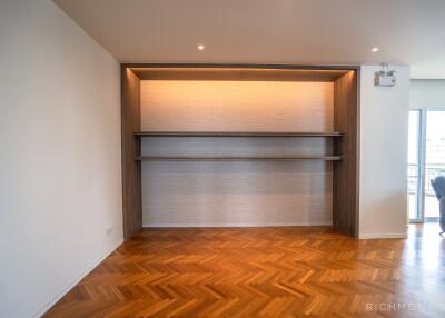 Modern living area with wooden flooring and built-in shelving