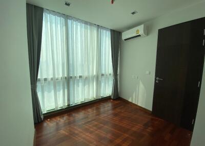 Bedroom with wooden floor and large window