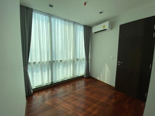 Bedroom with wooden floor and large window