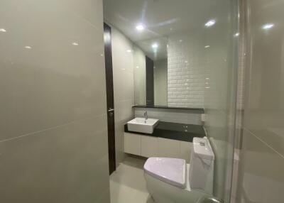 Modern bathroom with white tiles and fixtures