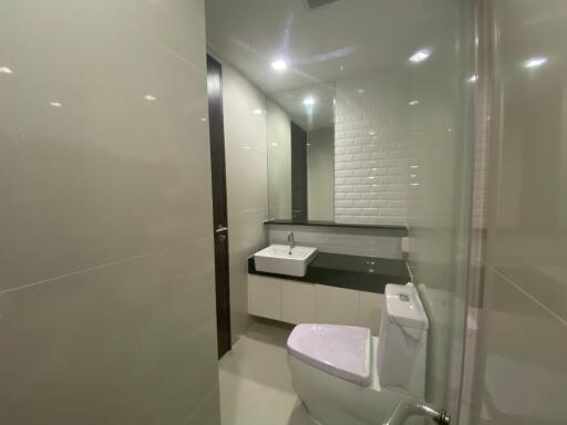 Modern bathroom with white tiles and fixtures