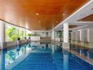 Indoor swimming pool area with wooden ceiling