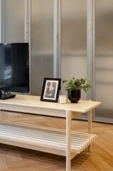 Living room with coffee table, TV, and decorative items