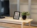 Living room with coffee table, TV, and decorative items