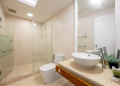 Modern bathroom with glass shower and white fixtures