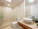 Modern bathroom with glass shower and white fixtures