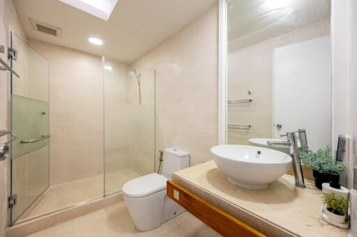 Modern bathroom with glass shower and white fixtures