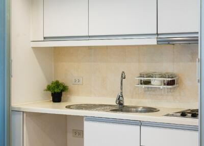 Clean modern small kitchen with white cabinets