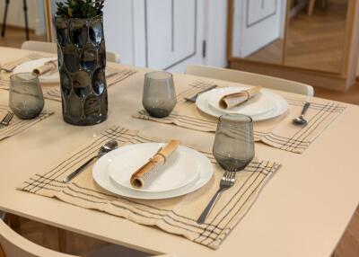 Dining table set with plates, cutlery, and glasses