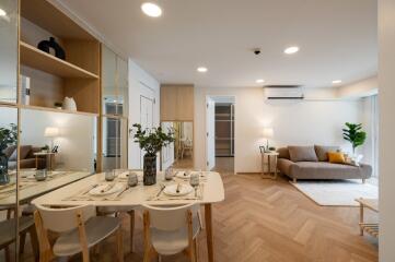 Modern living room with dining area and wooden flooring