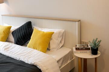 Cozy bedroom with gray and yellow cushions