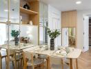 Modern dining area with white table, chairs, and mirrored walls