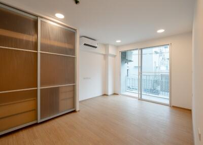 Bright and spacious living area with sliding door wardrobe and balcony access