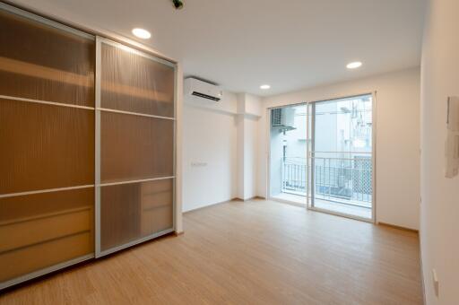 Bright and spacious living area with sliding door wardrobe and balcony access