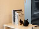 Close-up view of a side table in the living room with books and a TV