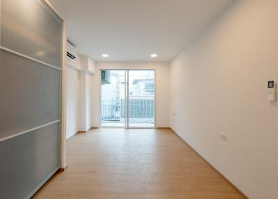 Minimalist living room with wooden floor and glass sliding doors