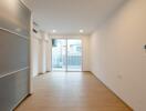 Minimalist living room with wooden floor and glass sliding doors