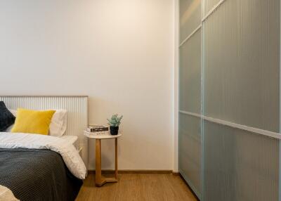 Cozy modern bedroom with bedside table and sliding door wardrobe