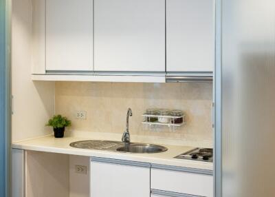 Modern kitchen with white cabinetry and stainless steel appliances