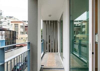 Covered balcony with railing and glass door