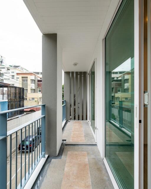 Covered balcony with railing and glass door