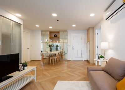 Modern open-plan living and dining room with wood flooring