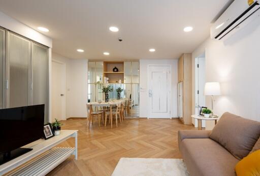 Modern open-plan living and dining room with wood flooring