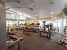 Well-equipped fitness center with various exercise machines and free weights