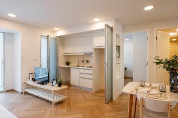 Modern open-plan living area with kitchenette and dining space