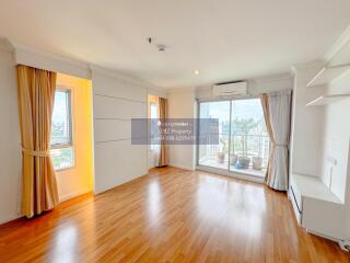 spacious living room with large windows and wooden flooring