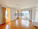 spacious living room with large windows and wooden flooring