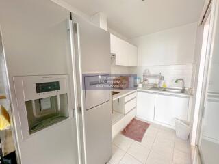 Modern kitchen with white cabinets and stainless steel appliances