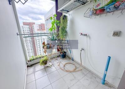 Balcony with plants, outdoor air conditioning unit, water tap, and city view