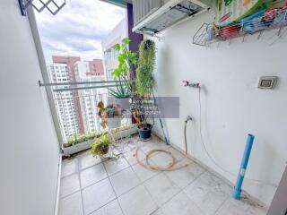 Balcony with plants, outdoor air conditioning unit, water tap, and city view