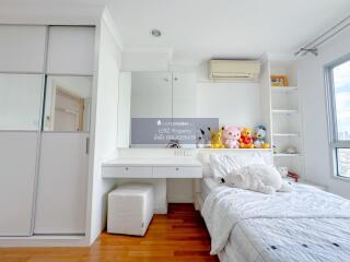 Modern bedroom with white furniture and plush toys