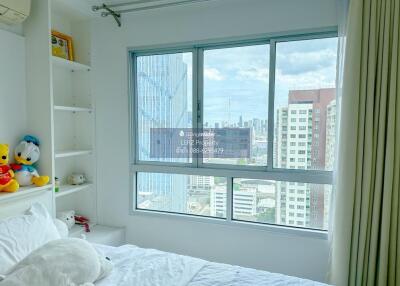 Bright bedroom with large window and city view