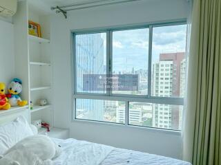 Bright bedroom with large window and city view