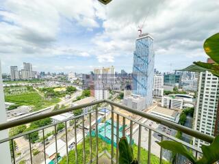 View of the city from the balcony with green spaces and high-rise buildings