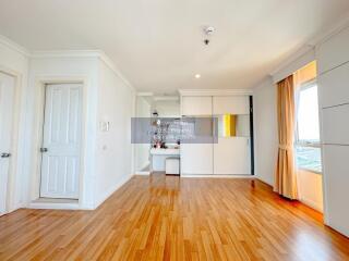 Spacious living room with wooden flooring and large windows