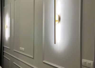 Well-lit bedroom wall with modern lighting and air conditioning