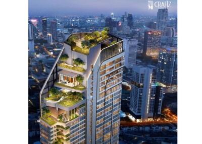 Modern high-rise building with terraces and greenery amidst city skyline at dusk