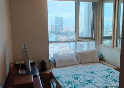 Bedroom with large window and city view