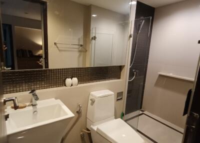 Modern bathroom with shower and large mirror