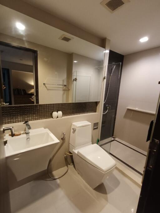 Modern bathroom with shower and large mirror