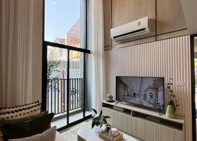 Modern living room with high ceiling and large window