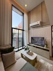 Modern living room with high ceiling and large window