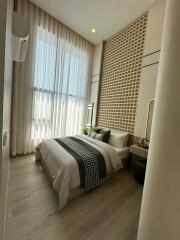 Modern bedroom with stylish decor and large windows